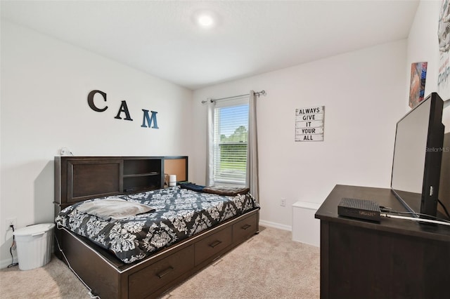 bedroom featuring baseboards and light carpet