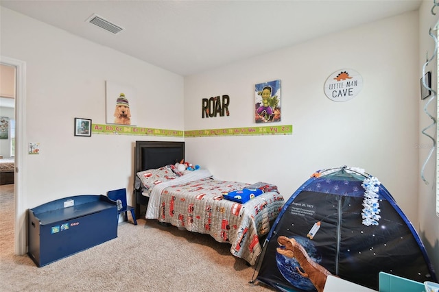 carpeted bedroom featuring visible vents