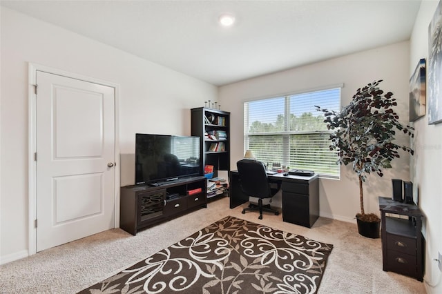 carpeted home office featuring baseboards