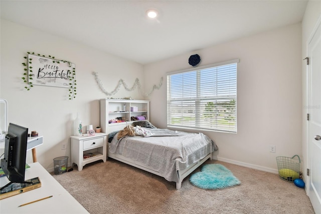 carpeted bedroom featuring baseboards