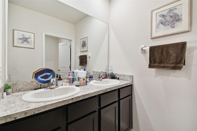 full bathroom featuring double vanity and a sink