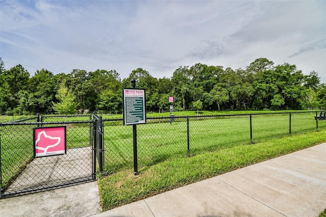 view of home's community featuring a gate, a yard, and fence