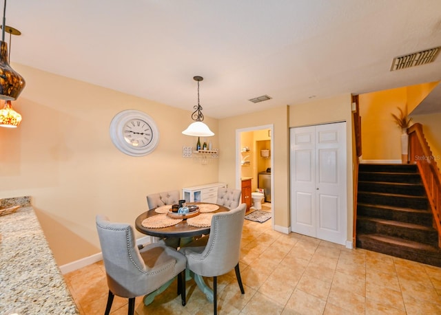 dining area featuring light tile patterned floors and washer / dryer