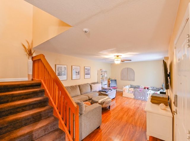 living room featuring ceiling fan and wood-type flooring