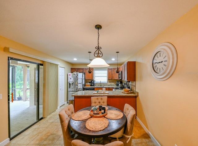 tiled dining area featuring sink