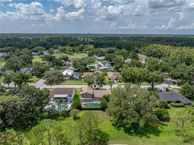 birds eye view of property featuring a forest view