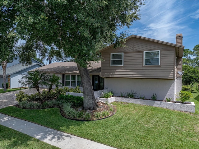 tri-level home featuring a front yard