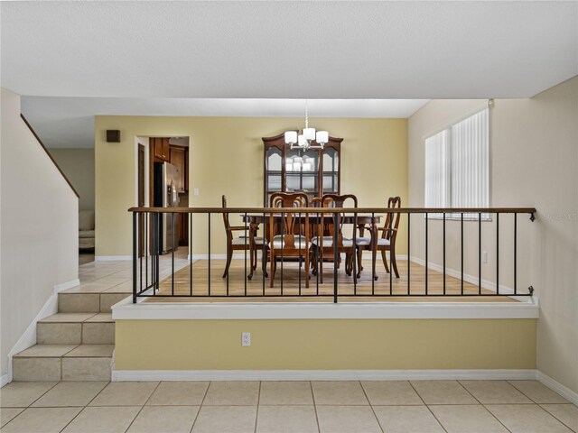 tiled dining space with a notable chandelier