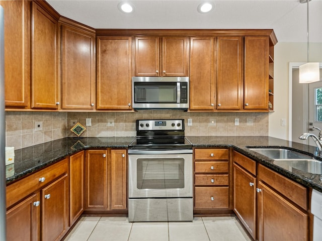 kitchen with light tile patterned floors, stainless steel appliances, and tasteful backsplash