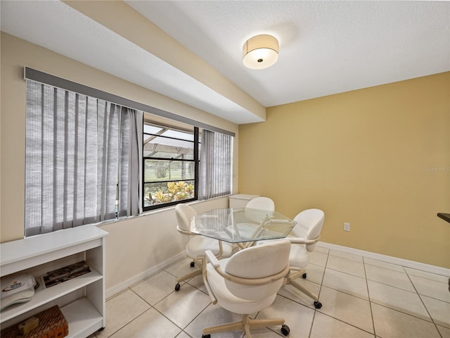 tiled dining room with a textured ceiling