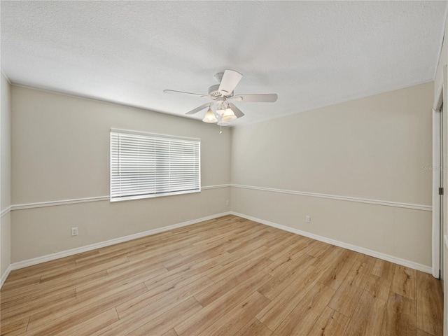 spare room featuring light wood-type flooring, a textured ceiling, and ceiling fan