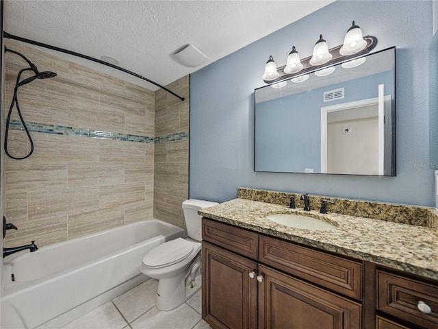 full bathroom with toilet, tile patterned floors, vanity, a textured ceiling, and tiled shower / bath combo