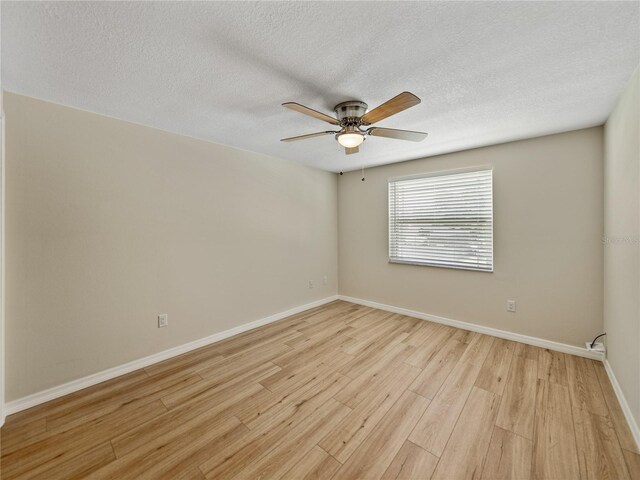 spare room featuring a textured ceiling, light hardwood / wood-style flooring, and ceiling fan