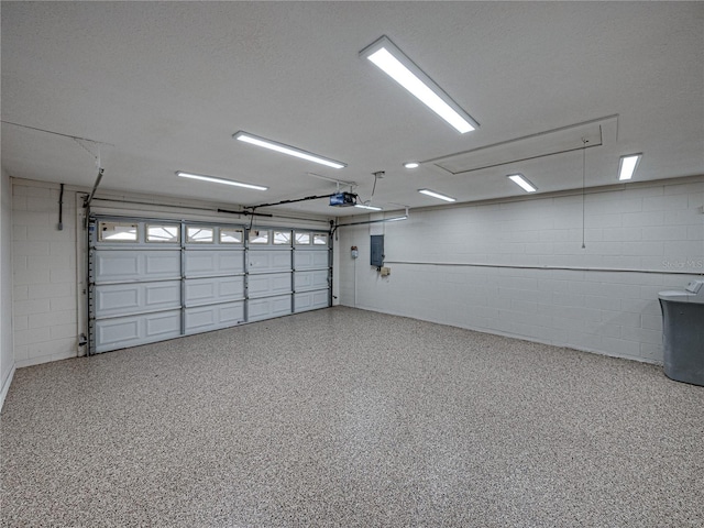 garage featuring a garage door opener and electric panel