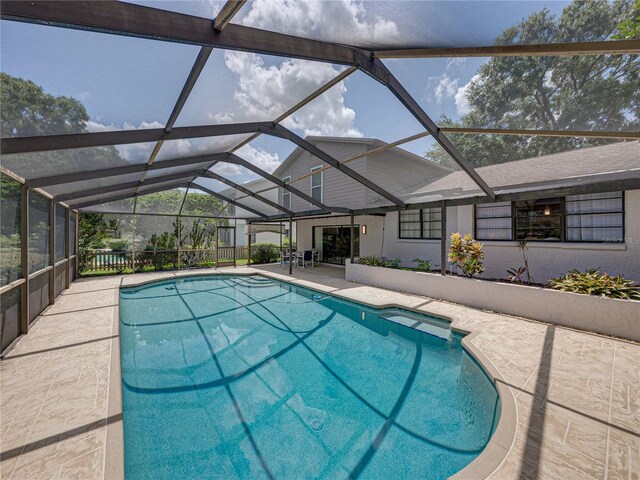 view of pool with a patio and a lanai