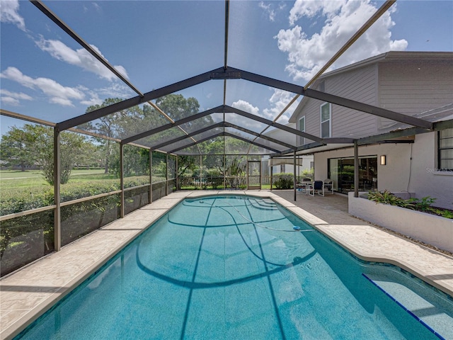 view of swimming pool featuring a lanai and a patio area