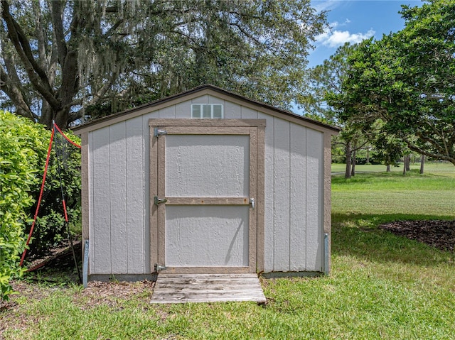 view of outbuilding featuring a yard