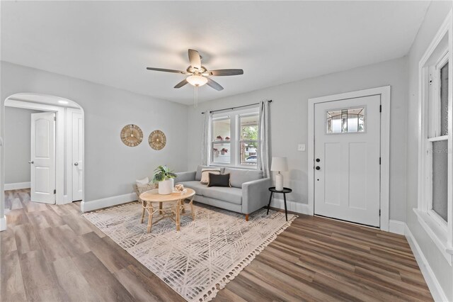 living room featuring hardwood / wood-style flooring and ceiling fan