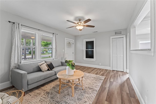 living room featuring ceiling fan and hardwood / wood-style flooring