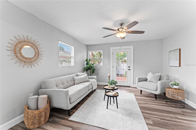 living room with ceiling fan and dark hardwood / wood-style floors