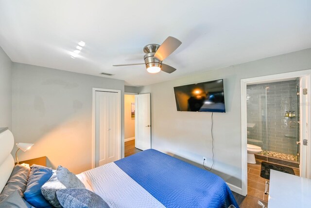 bedroom featuring a closet, ceiling fan, and ensuite bathroom