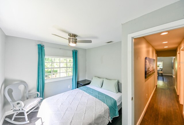 bedroom with ceiling fan and dark hardwood / wood-style flooring