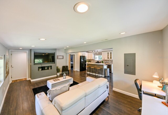 living room with electric panel and dark hardwood / wood-style floors