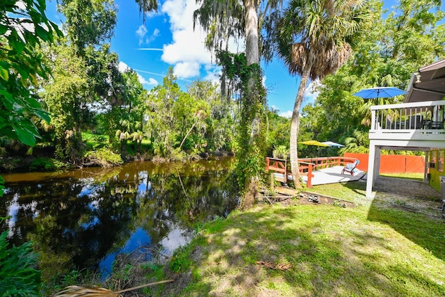 view of yard featuring a deck with water view