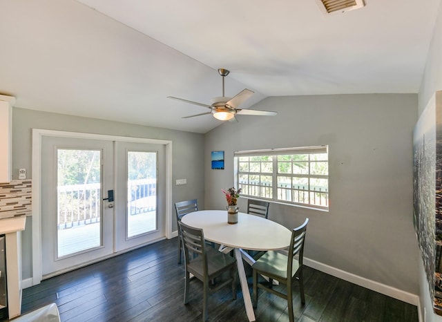 dining area with dark hardwood / wood-style flooring, vaulted ceiling, ceiling fan, and french doors