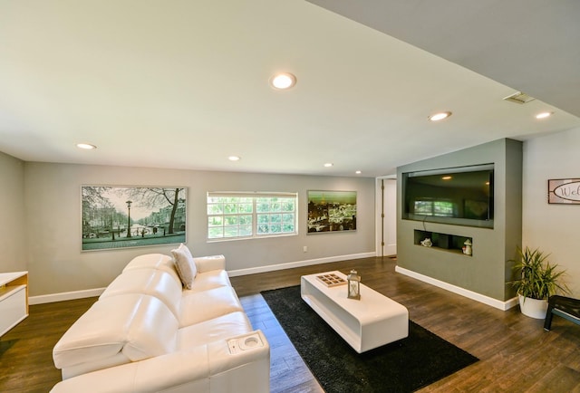 living room with dark wood-type flooring and vaulted ceiling