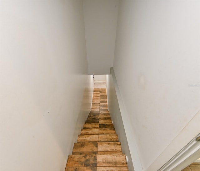 stairway featuring wood-type flooring