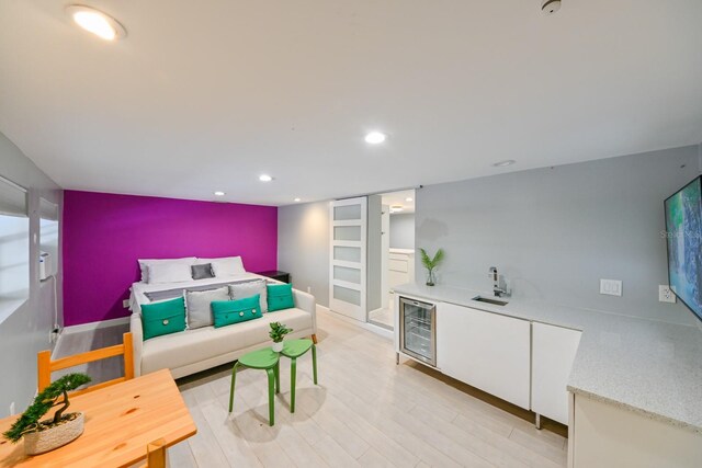 bedroom featuring light wood-type flooring and beverage cooler