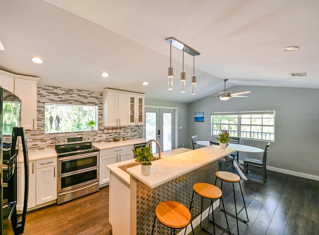 kitchen with ceiling fan, refrigerator, white cabinets, and stainless steel range with electric stovetop