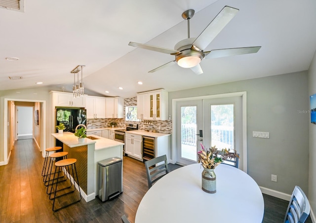 4617 John Moore Rd, Brandon, FL 33511 - kitchen featuring black fridge with ice dispenser, electric range, wine cooler, tasteful backsplash, and light countertops