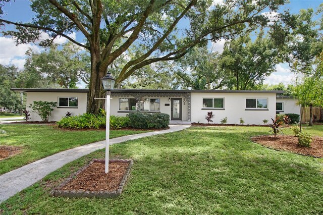 ranch-style house with a front lawn