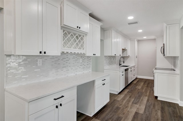 kitchen featuring dark hardwood / wood-style floors, stainless steel appliances, sink, decorative backsplash, and white cabinetry