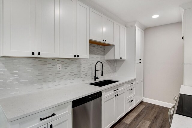 kitchen with dark hardwood / wood-style floors, appliances with stainless steel finishes, sink, light stone counters, and white cabinets