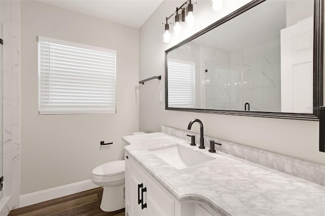 bathroom with vanity, toilet, hardwood / wood-style floors, and an enclosed shower