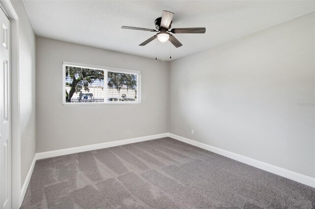 carpeted empty room featuring ceiling fan