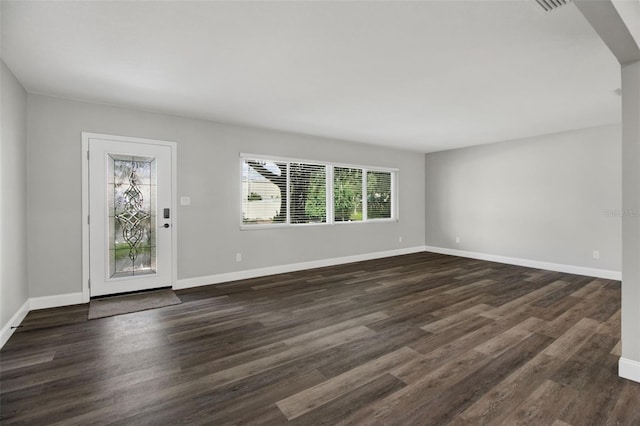 interior space with dark wood-style flooring and baseboards