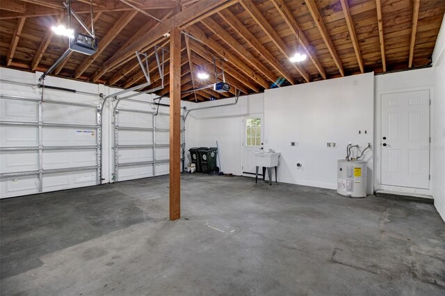 garage with electric water heater, a garage door opener, and sink