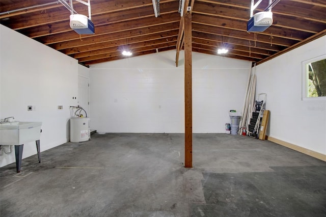 garage featuring electric water heater and a garage door opener