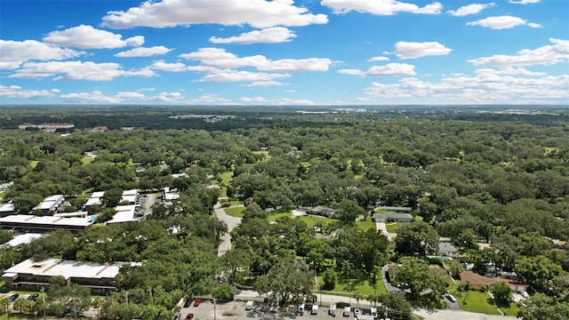 drone / aerial view featuring a wooded view