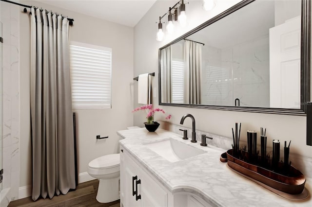 bathroom featuring a shower, toilet, hardwood / wood-style floors, and vanity