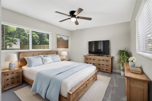 bedroom with ceiling fan, multiple windows, and carpet flooring