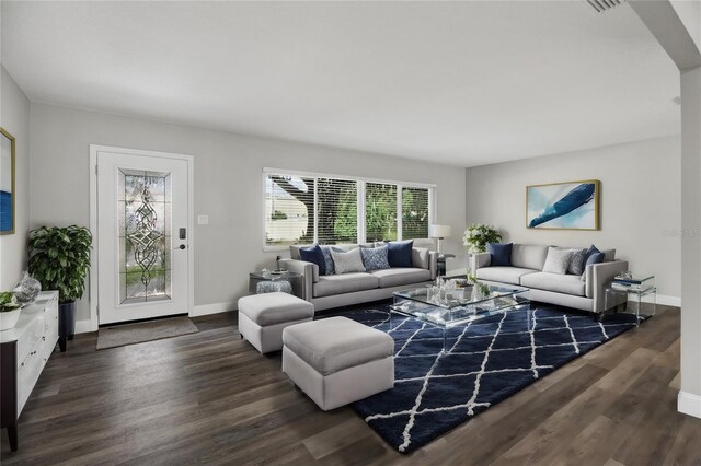 living room with dark hardwood / wood-style flooring