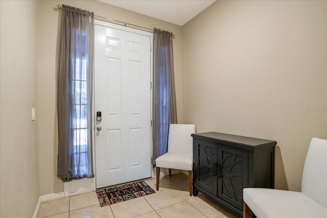 foyer with baseboards and light tile patterned flooring