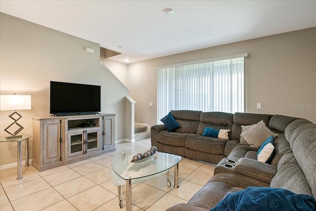 living room with light tile patterned floors and baseboards