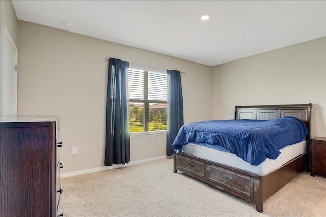 bedroom with baseboards, recessed lighting, and light colored carpet