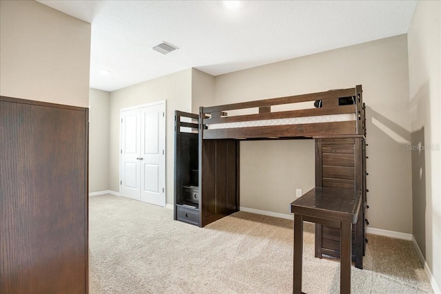 bedroom featuring light colored carpet, visible vents, and baseboards